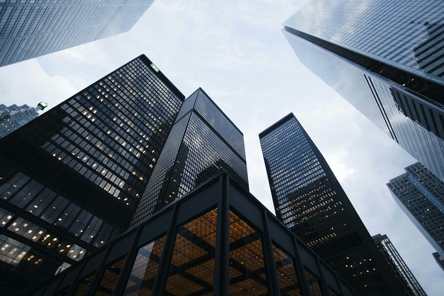 Looking upward between contemporary office towers